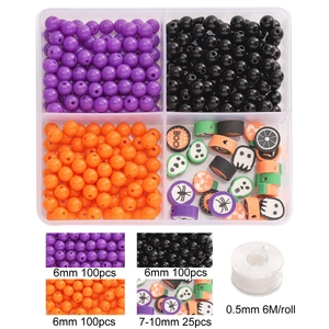 Halloween DIY bead set with purple orange beads and ghost clay charms in a 4-grid box