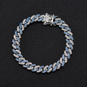 Detail of silver Cuban link bracelet with micro-paved blue and white rhinestones