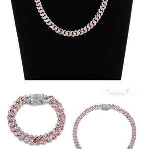 Close-up of pink and white iced-out Cuban link chain necklace and bracelet set
