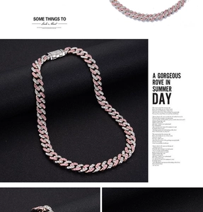 Macro detail of luxury Cuban link chain necklace with pink and clear crystals