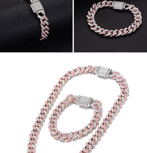 Detail of pink and white iced-out Cuban link jewelry set with sparkling crystals