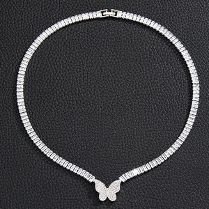 Detailed close-up of a silver butterfly pendant with micro-pave cubic zirconia on black leather