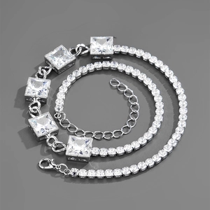 Detail of silver Cuban chain with rectangular zircon stones and lobster clasp closure