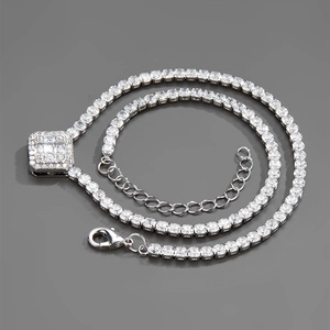 Detail of silver tennis chain necklace with a square cubic zirconia pavé pendant