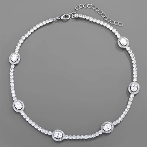 Macro detail of silver necklace featuring pave-set cubic zirconia and oval focal stones