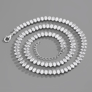 Macro view of marquise-cut zircon stones on a silver-plated Cuban link chain necklace
