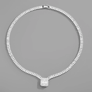 Macro view of silver cubic zirconia necklace featuring rectangular baguette stones and foldover clasp