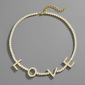 Detail shot of gold-plated LOVE letter necklace with sparkling white pavé cubic zirconia