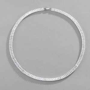 Macro view of silver cubic zirconia tennis necklace with rectangular baguette cut stones
