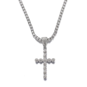 Detailed view of silver iced out hip hop cross pendant with tennis chain and clear stones