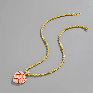 Detail of hip hop broken heart pendant with red enamel and white rhinestones
