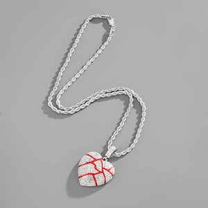 Macro shot of hip hop broken heart pendant with shiny silver rhinestones and red cracks