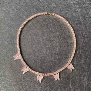 Close-up of rose gold tennis necklace featuring pink zircon stones and butterfly charms