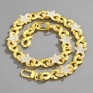 Detail of gold Cuban link jewelry set with star pendants and sparkling crystal accents
