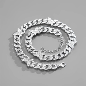 Silver Cuban link necklace with five butterfly pendants encrusted with white rhinestones