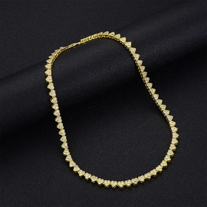 Luxurious gold heart necklace with micro-pave zircon crystals on a black jewelry pillow