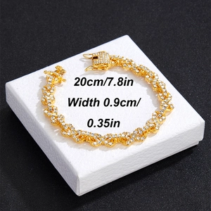 Macro view of gold Cuban chain bracelet with pave diamonds on a black jewelry box