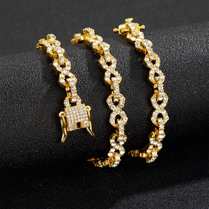 Macro view of iced out gold plated Cuban chain with densely pavé set white crystals