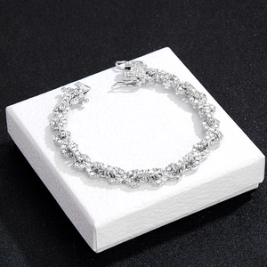 Detail of silver iced-out cuban chain bracelet with white cubic zirconia inlays