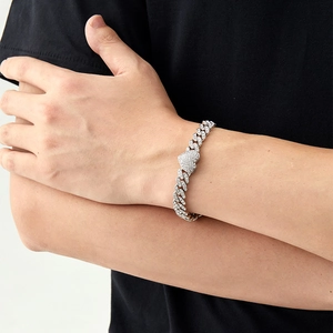 Close-up of iced out heart Cuban chain bracelet with silver plating and zircon stones