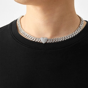 Detail of hip hop Cuban link chain necklace with a large iced-out heart pendant