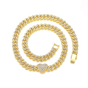 Detailed close-up of 9mm golden Cuban chain necklace with iced-out heart pendant and clasp