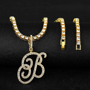 Close-up of gold hip hop letter B pendant with tennis chain and pavé zircon stones