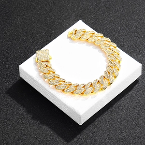Vue macro du bracelet cubain doré glacé avec strass scintillants et fermoir à boîte sécurisé