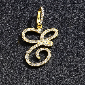 Detailed close-up of hip hop cursive letter E pendant in gold with sparkling crystals