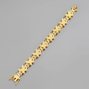 Détail de maillons papillon dorés sur collier hip hop avec sertissage de zircons cubiques