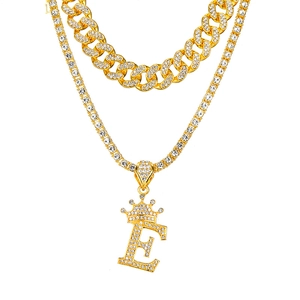 Macro shot of hip hop gold plated crown letter E pendant with double layer iced out chains