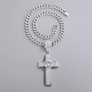 Detail of hip hop silver cross pendant with skull design and shimmering crystals