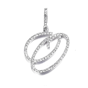 Macro detail of cursive letter O pendant with pavé set cubic zirconia in silver tone