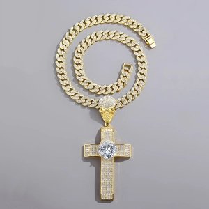 Hip hop iced out skull cross pendant with white zircons on a golden Cuban chain