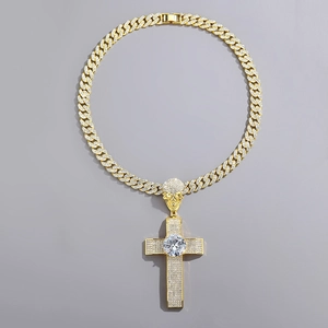 Detailed close-up of a gold hip hop cross pendant with skull detail and pavé diamonds