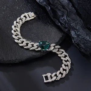 Detail of silver Cuban link bracelet with green heart gem and 20cm length dimension