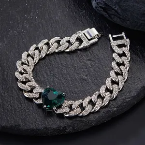 Silver iced-out Cuban chain bracelet with a heart-shaped green emerald centerpiece