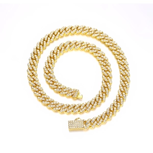Detailed macro view of 9mm golden Cuban link chain with paved rhinestones and secure clasp