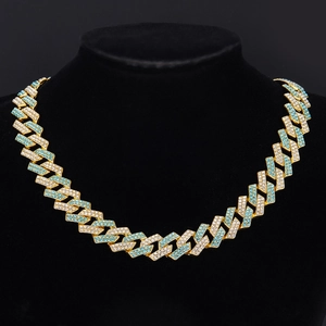 Macro shot of Z-shape Cuban chain with white and light blue rhinestones on black bust