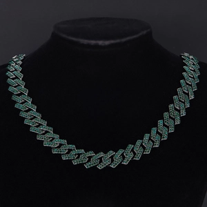 Detailed view of hip hop cuban link chain set with vibrant green emerald rhinestones