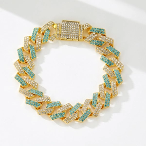 Detail of gold Cuban chain with blue and white rhinestones and a wide square buckle