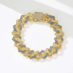 Detail of gold Cuban link chain with blue and white crystals and square box clasp