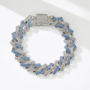 Macro detail of silver hip-hop Cuban link chain featuring blue and white rhinestones
