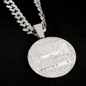 Close-up of iced out Cuban chain and Last Supper relief pendant with crystal pavé