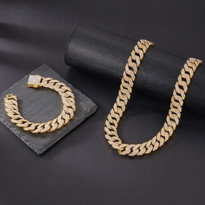 Detailed view of gold-plated Cuban link necklace set with sparkling crystal pave setting