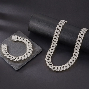 Macro shot of silver hip hop Cuban link set with triple row stones and security buckle