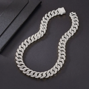 Detailed close-up of triple-row rhinestone Cuban chain with iced-out folding clasp