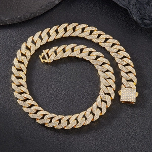 Detailed macro view of iced out golden Cuban link chain with sparkling zircon stones