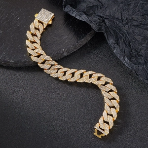Close-up of golden Cuban link bracelet with three rows of sparkling crystal inlays