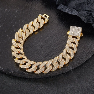 Macro view of iced out gold Cuban link chain with detailed pave crystal setting